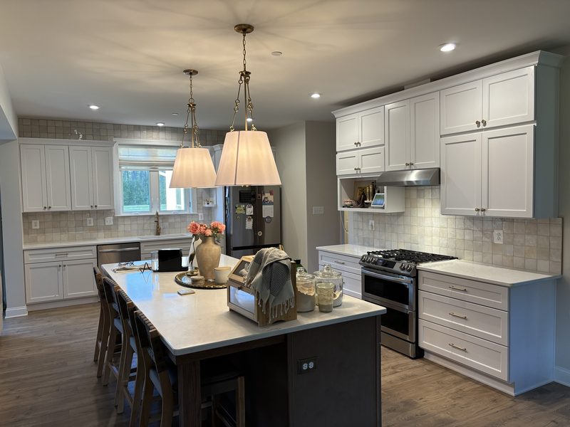 Finished kitchen with white cabinetry and a tiled backsplash